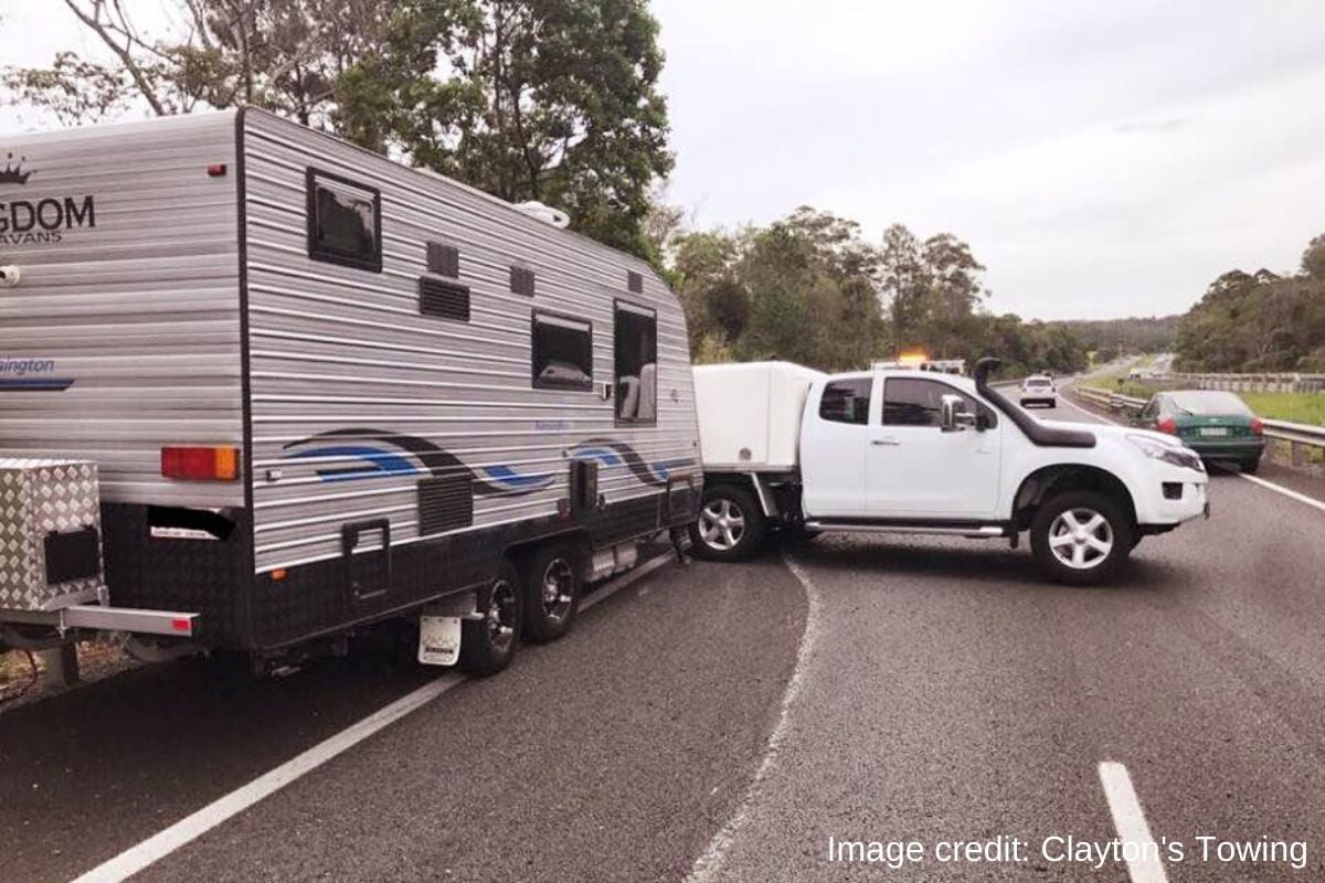 A car and caravan jack-knife on the Bruce Highway. Image credit: Clayton's Towing.